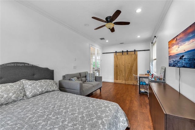 bedroom featuring ceiling fan, a barn door, crown molding, and dark wood-type flooring