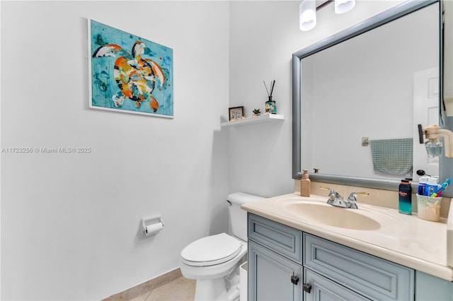 bathroom featuring tile patterned flooring, vanity, and toilet