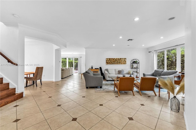 living room featuring light tile patterned floors and crown molding