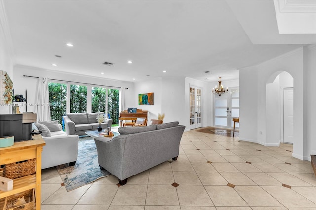 tiled living room featuring french doors, crown molding, and a notable chandelier