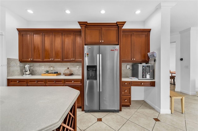 kitchen with tasteful backsplash, stainless steel fridge with ice dispenser, and light tile patterned flooring