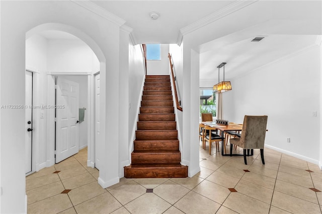 staircase featuring tile patterned floors and ornamental molding