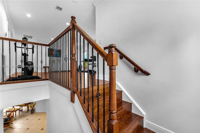 staircase featuring tile patterned flooring and ornamental molding