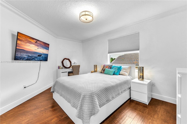 bedroom featuring dark hardwood / wood-style flooring, a textured ceiling, and ornamental molding