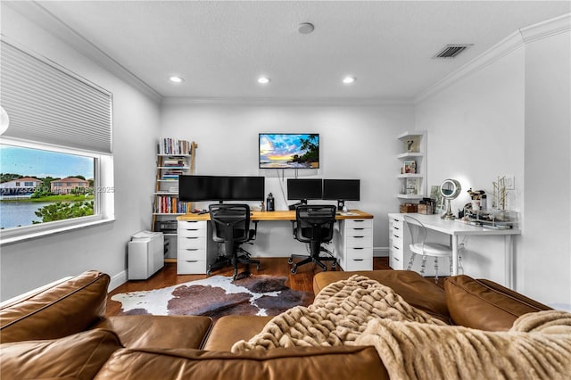 office space with a textured ceiling, a water view, wood-type flooring, and ornamental molding