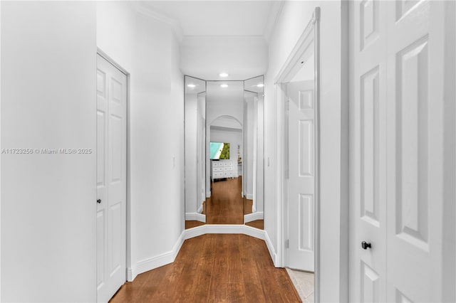 corridor with crown molding and hardwood / wood-style floors