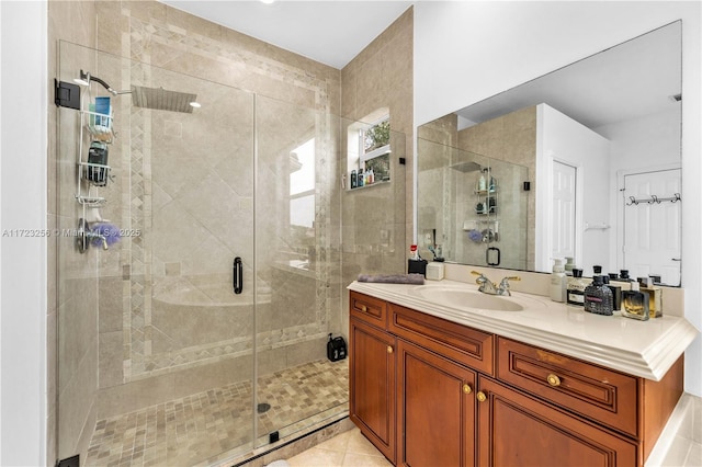 bathroom featuring vanity, tile patterned floors, and walk in shower