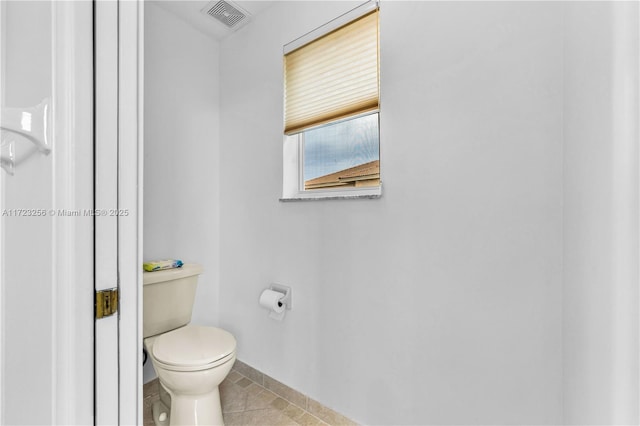 bathroom with tile patterned floors and toilet