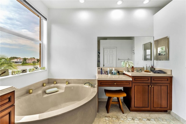 bathroom with vanity, tile patterned floors, and a bathing tub