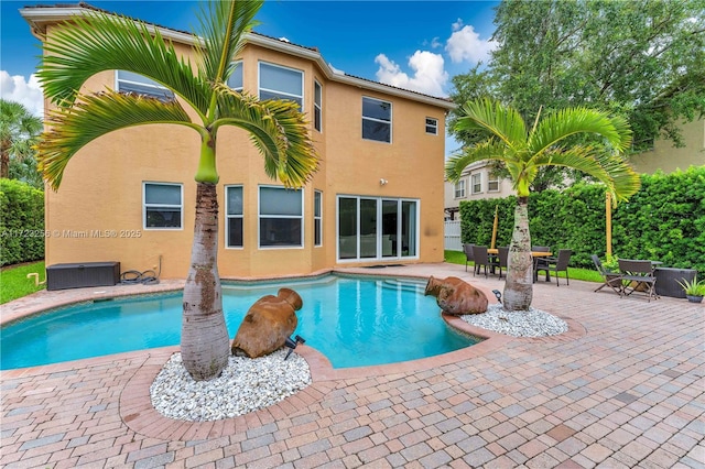 view of pool featuring a patio and central air condition unit