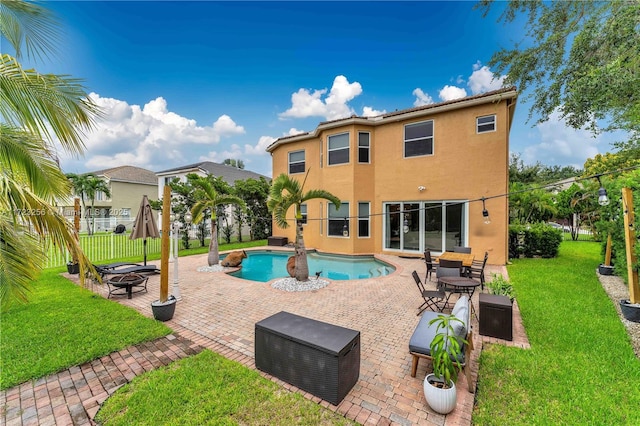 view of pool featuring a patio area, a yard, and a fire pit