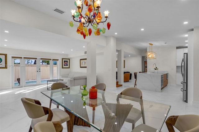 dining room featuring sink and an inviting chandelier