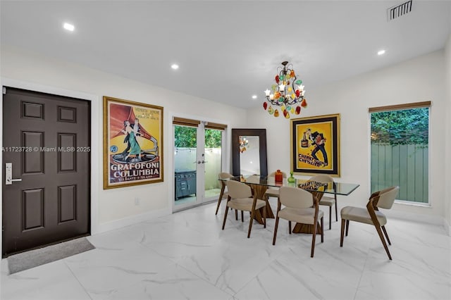 dining room featuring french doors and a notable chandelier