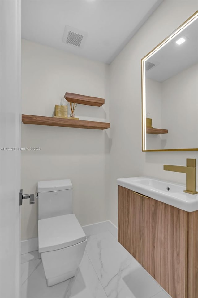 bathroom with vanity and toilet