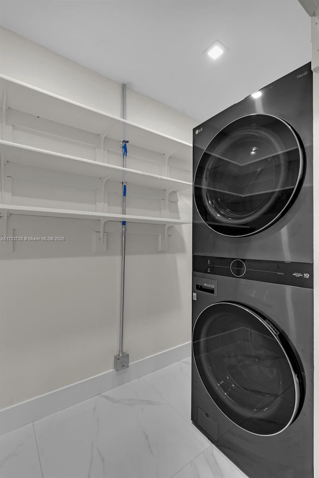 laundry area featuring stacked washer and clothes dryer