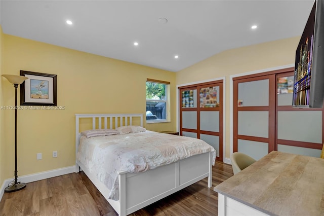 bedroom featuring hardwood / wood-style flooring and vaulted ceiling