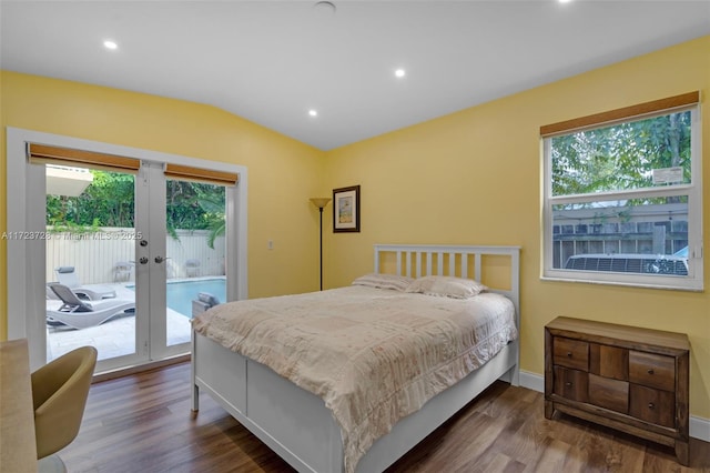 bedroom with access to outside, dark hardwood / wood-style flooring, french doors, and lofted ceiling