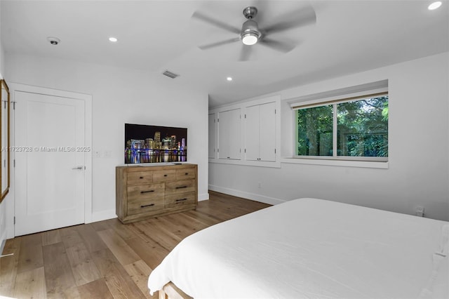 bedroom featuring hardwood / wood-style flooring, ceiling fan, and lofted ceiling