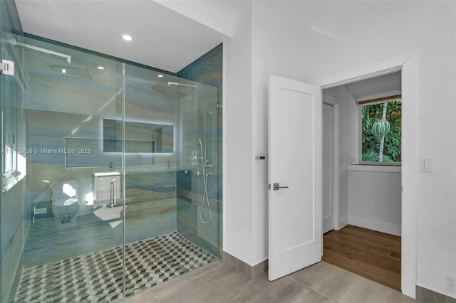 bathroom featuring tile patterned floors, toilet, and walk in shower