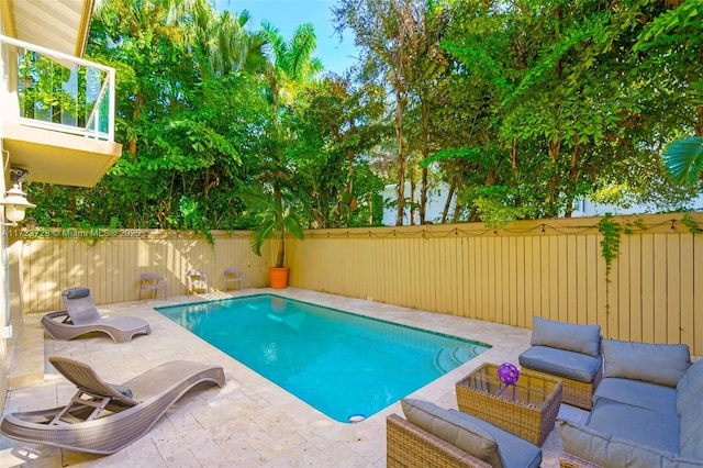 view of swimming pool with an outdoor living space and a patio area