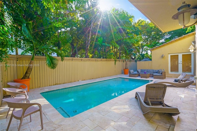 view of swimming pool featuring french doors, a patio, and an outdoor hangout area