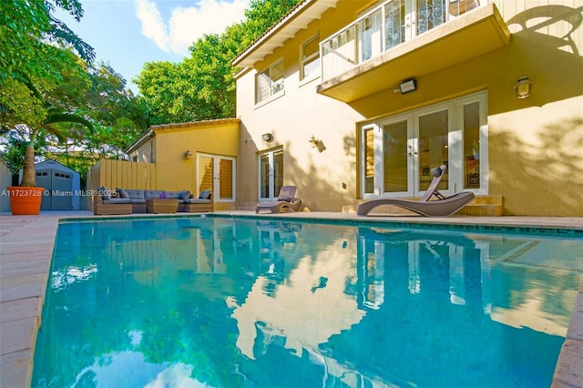 view of swimming pool with french doors and an outdoor hangout area