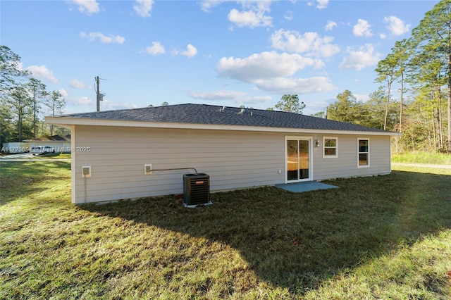 back of house with a lawn and central AC