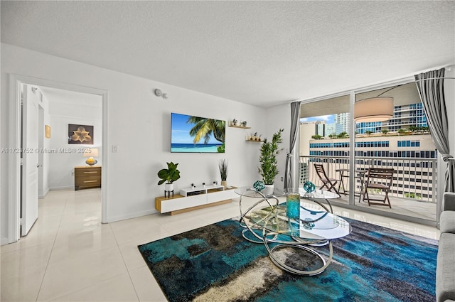 tiled living room with a textured ceiling and floor to ceiling windows