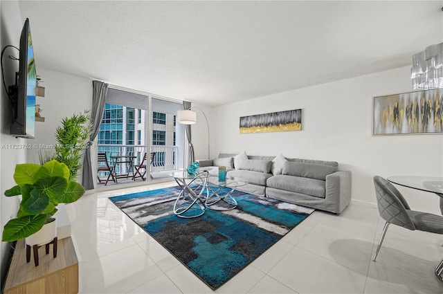 living room featuring tile patterned flooring and a wall of windows