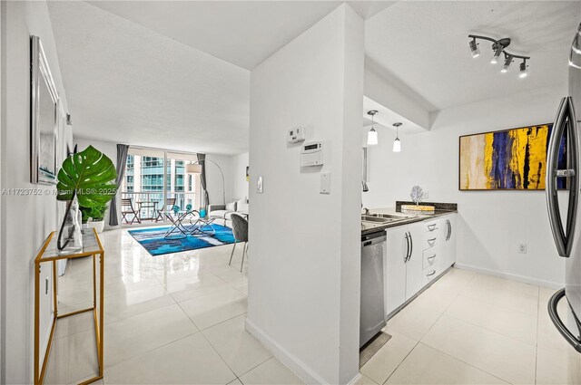 kitchen with light tile patterned flooring and stainless steel appliances