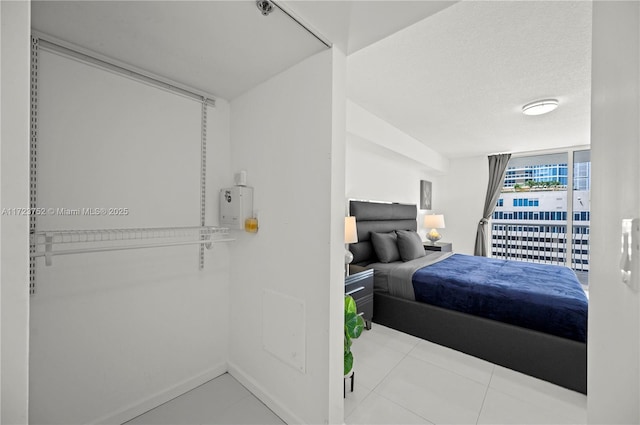 bedroom featuring light tile patterned floors and a textured ceiling