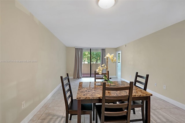 tiled dining room with floor to ceiling windows