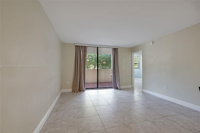 unfurnished room featuring light tile patterned floors and a wall of windows