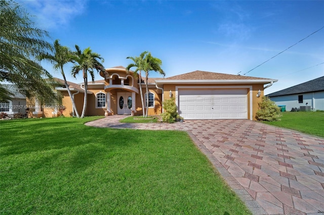 ranch-style home with a garage and a front lawn