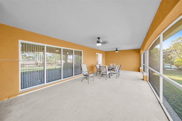 sunroom featuring ceiling fan