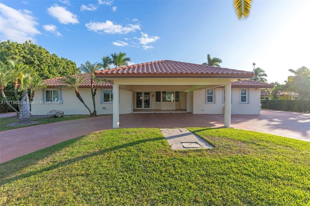 rear view of property with a lawn