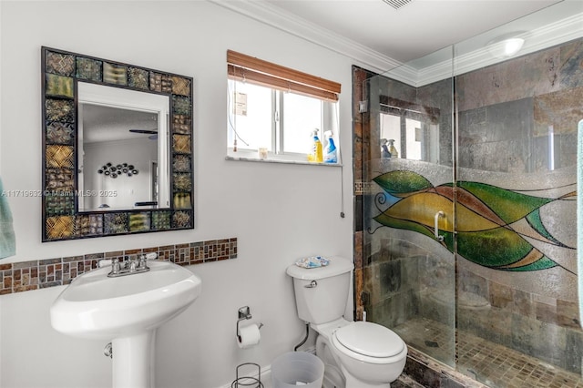 bathroom featuring toilet, ornamental molding, a shower with shower door, and tasteful backsplash