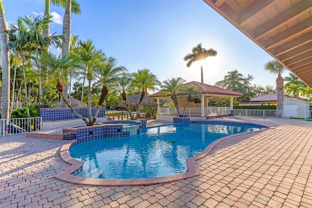 view of pool with a patio, an in ground hot tub, and a gazebo