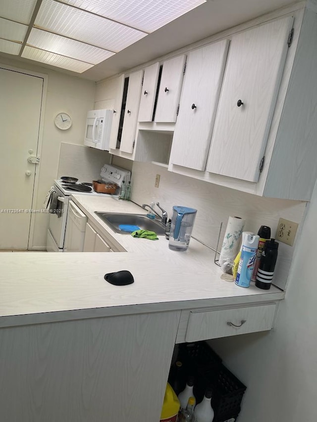 kitchen featuring sink and white appliances