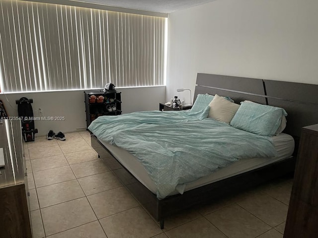 bedroom with light tile patterned floors