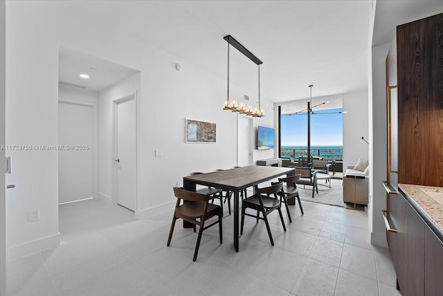 dining space featuring an inviting chandelier and floor to ceiling windows