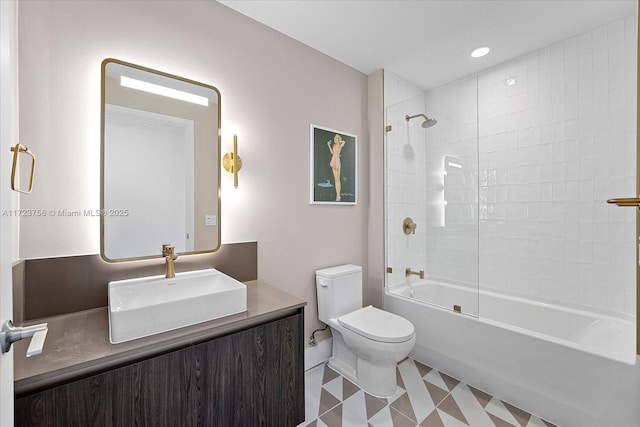 full bathroom with vanity, tiled shower / bath combo, and toilet