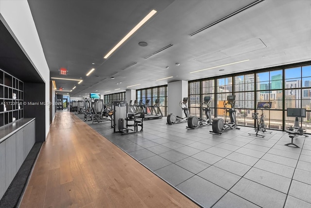 workout area featuring hardwood / wood-style flooring and expansive windows