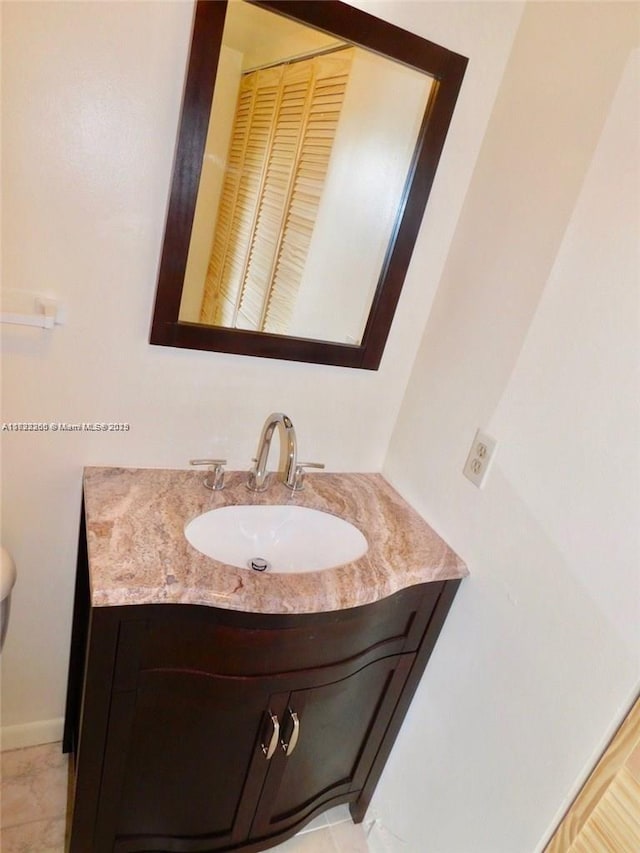 bathroom with tile patterned floors and vanity