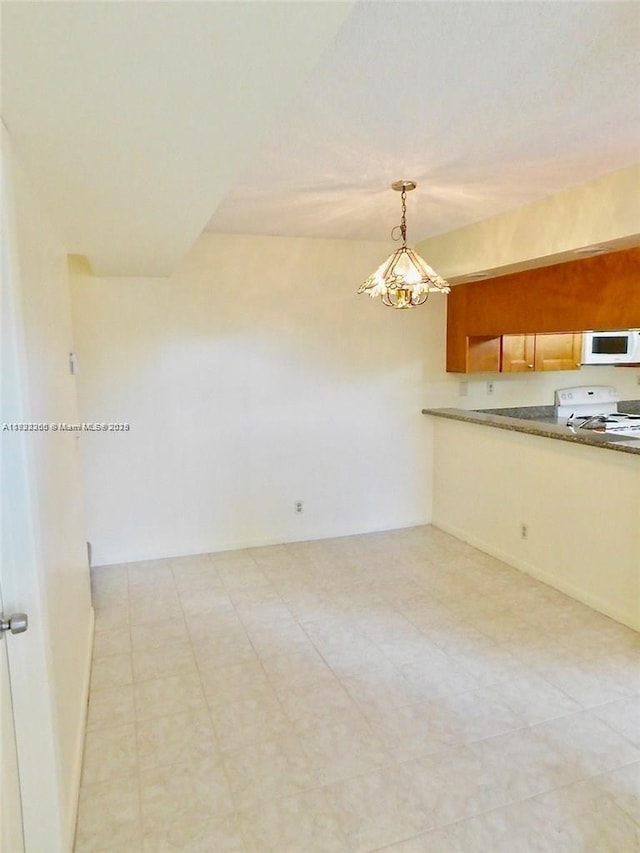 kitchen with white appliances and hanging light fixtures