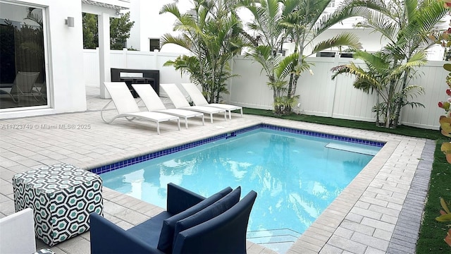 view of pool featuring a fenced backyard, a fenced in pool, and a patio