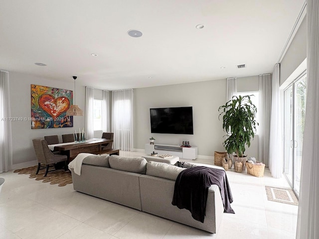 living area with recessed lighting and visible vents