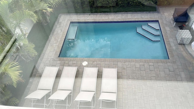 outdoor pool with a patio area