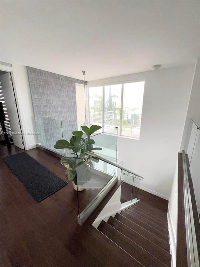 stairs featuring baseboards and wood finished floors