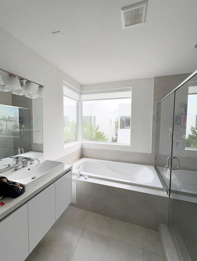 bathroom with a shower stall, vanity, visible vents, and tile patterned floors